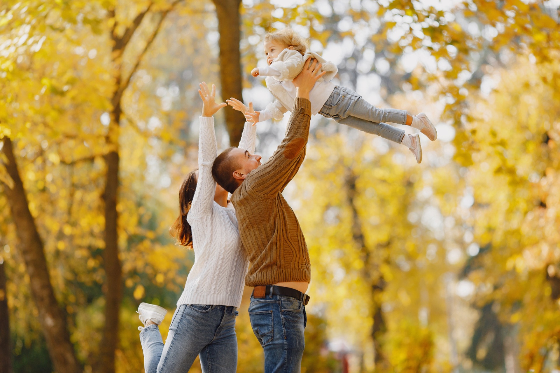 Happy family playing together in autumn park
