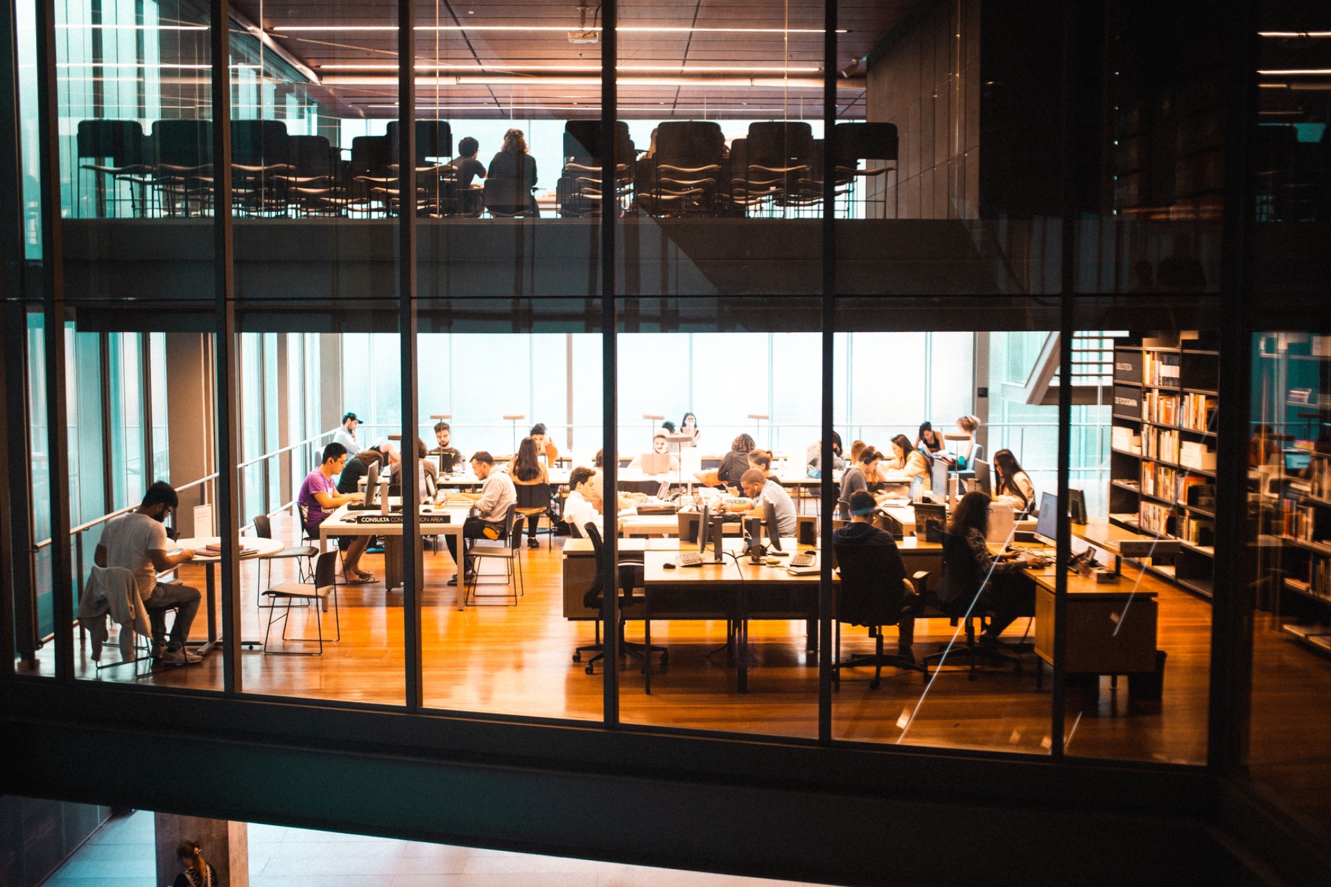 Modern glass office building with people working